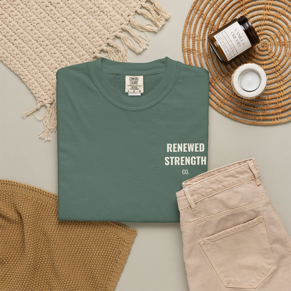 Suffering Produces Hope Romans 5:3-4 tee in blue spruce, folded flat lay mockup