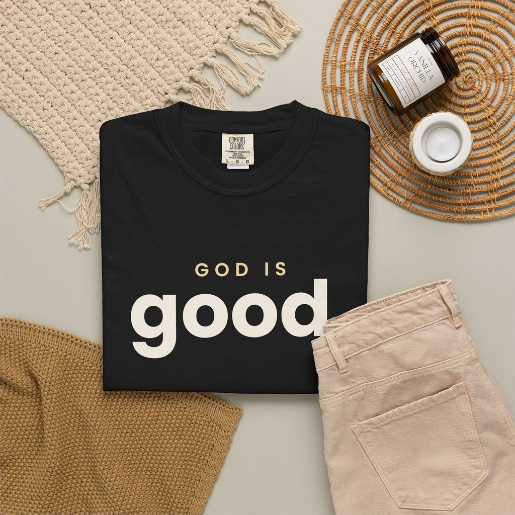 God Is Good Christian tee in black, folded flat lay