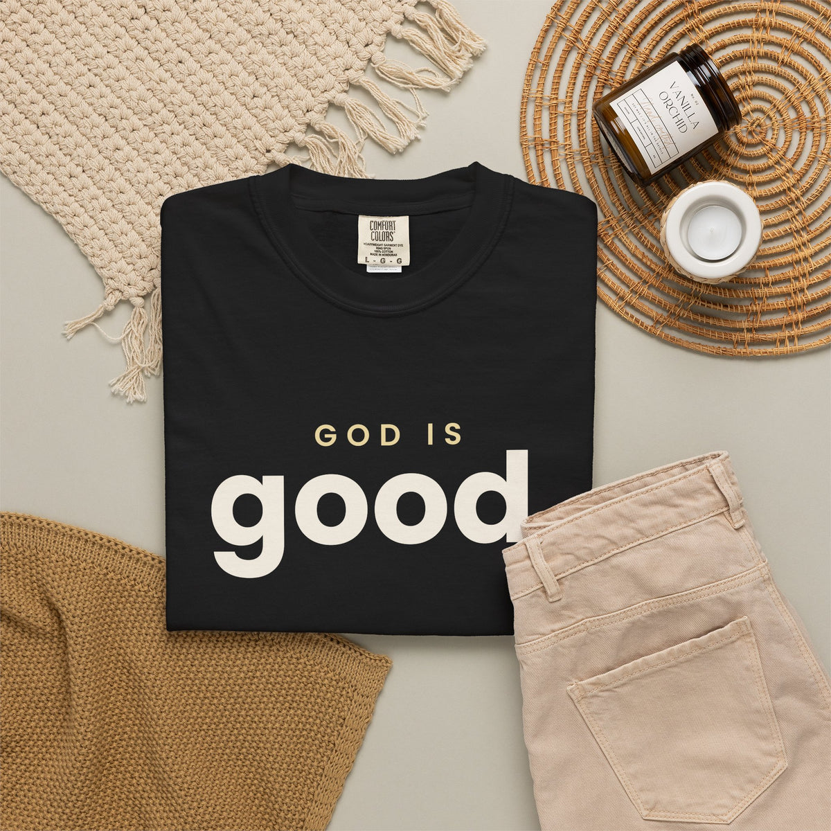 God Is Good Christian tee in black, folded flat lay