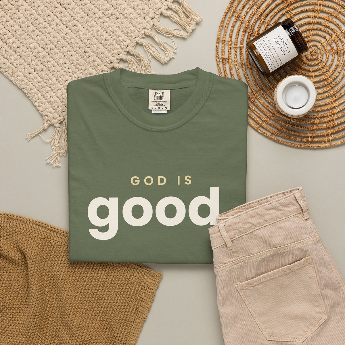 God Is Good Christian tee in sage, folded flat lay