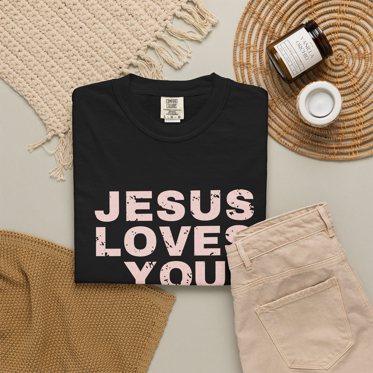 Jesus Loves You Christian tee in black, folded flat lay