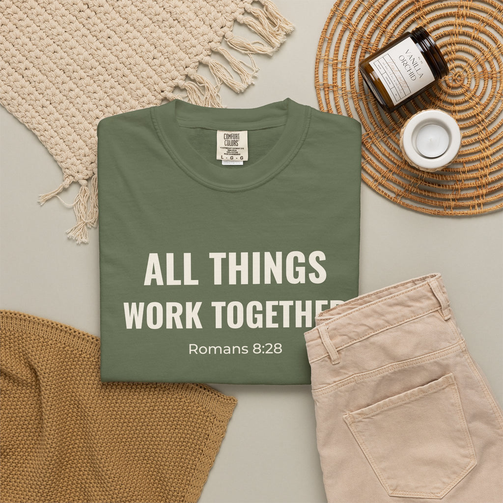 All Things Work Together Romans 8:28 tee in sage, folded flat lay mockup