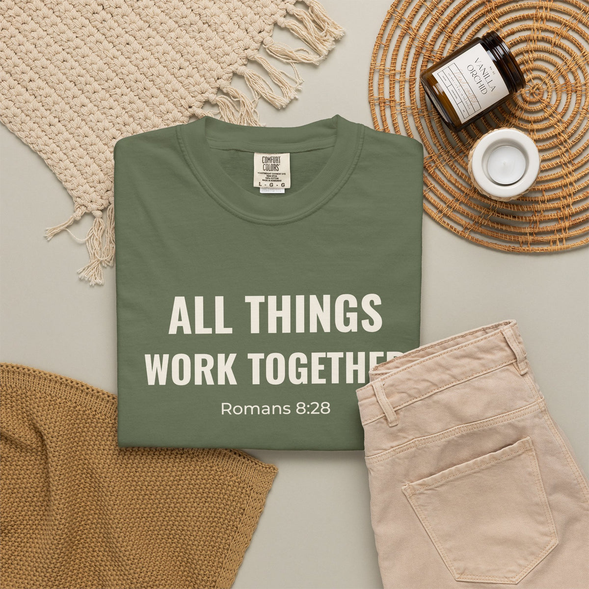 All Things Work Together Romans 8:28 tee in sage, folded flat lay mockup