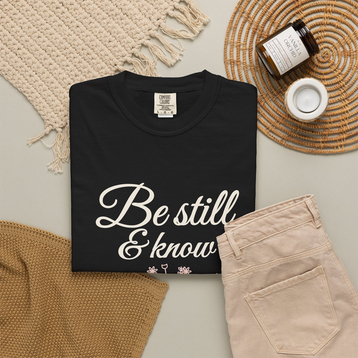 Be Still & Know Wildflower Psalm 46:10 Christian tee in black, folded flat lay