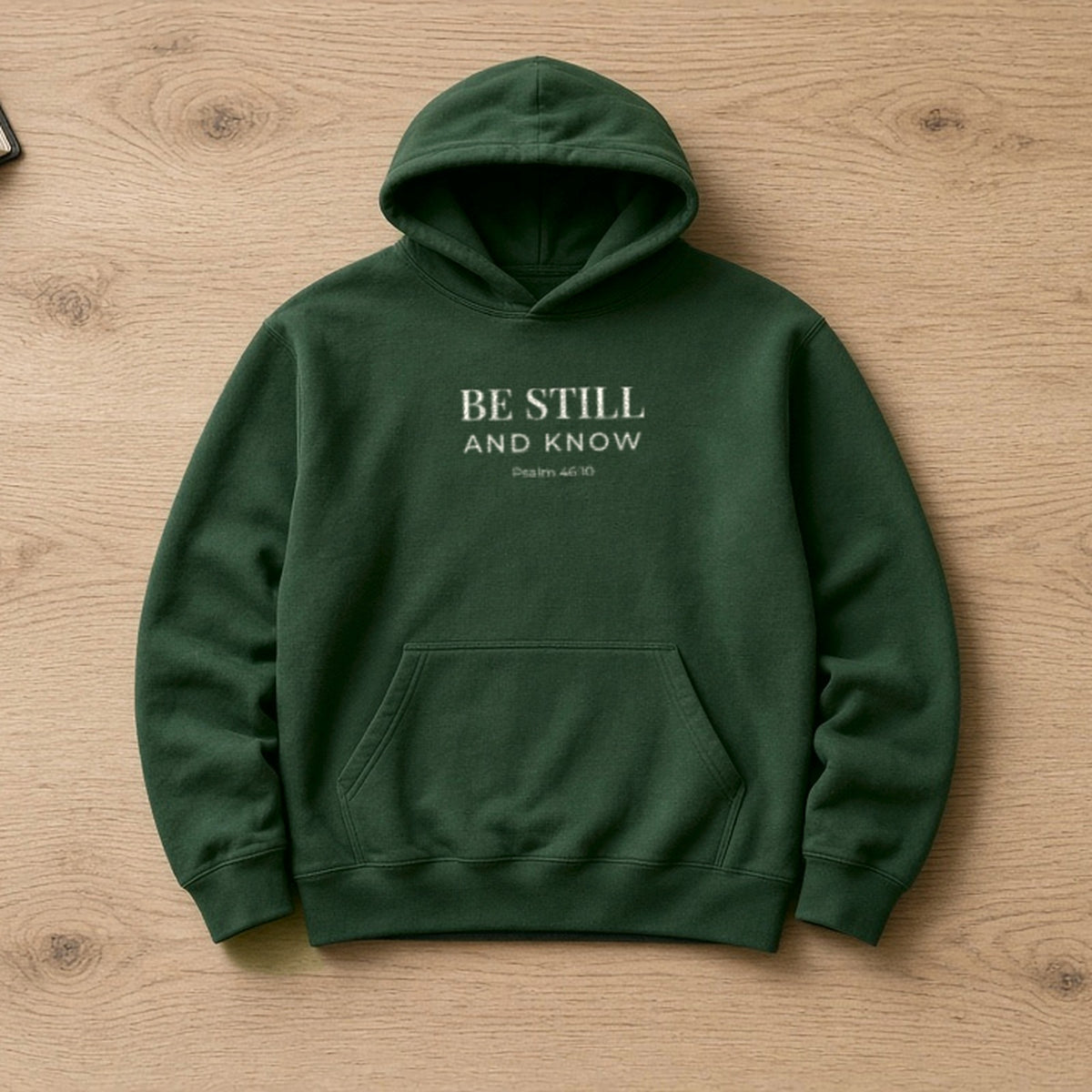 Be Still and Know Psalm 46:10 forest green hoodie, flat lay