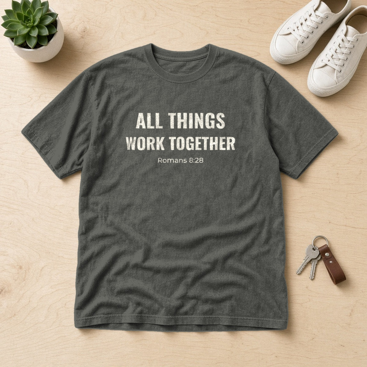 All Things Work Together Romans 8:28 pepper tee, flat lay
