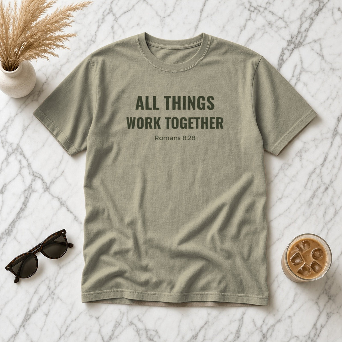 All Things Work Together Romans 8:28 sandstone tee, flat lay