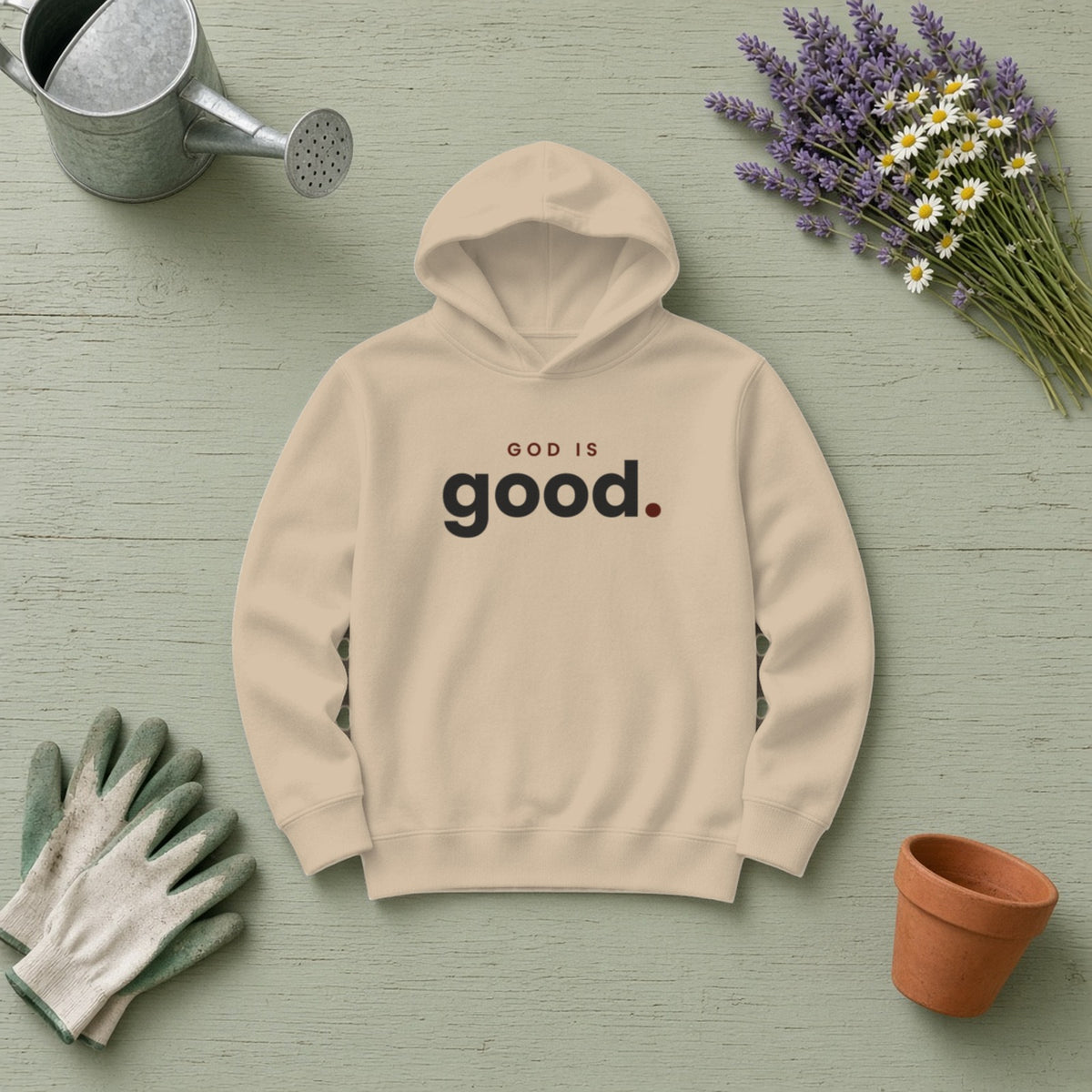 God Is Good Christian hoodie in sand, styled flat lay