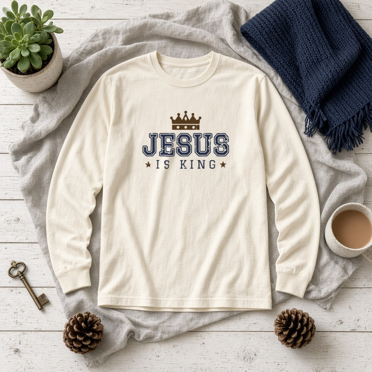Jesus Is King Christian long sleeve tee in ivory, styled flat lay
