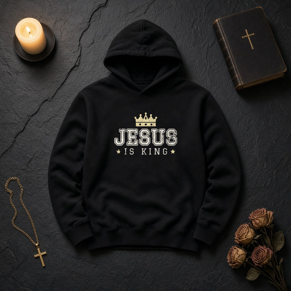 Jesus Is King Christian hoodie in black, styled flat lay