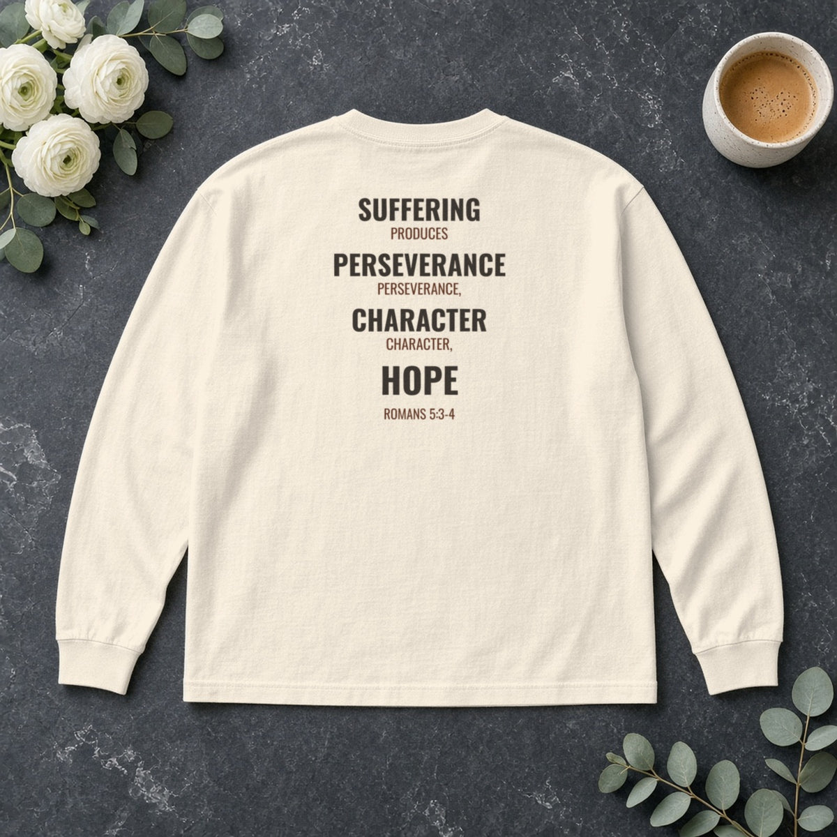 Suffering Produces Hope Romans 5:3-4 ivory long sleeve tee, flat lay (back view)