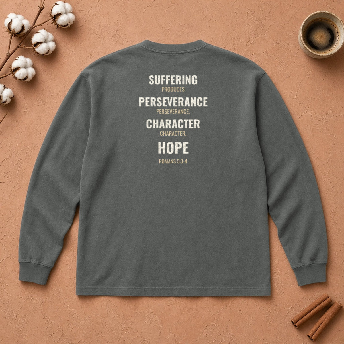 Suffering Produces Hope Romans 5:3-4 pepper long sleeve tee, flat lay (back view)