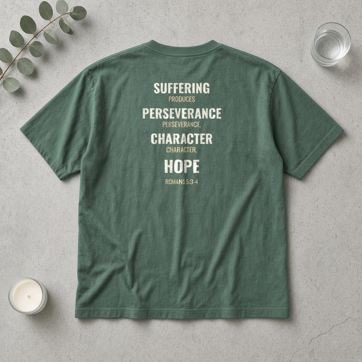 Suffering Produces Hope Romans 5:3-4 blue spruce tee, flat lay (back view)