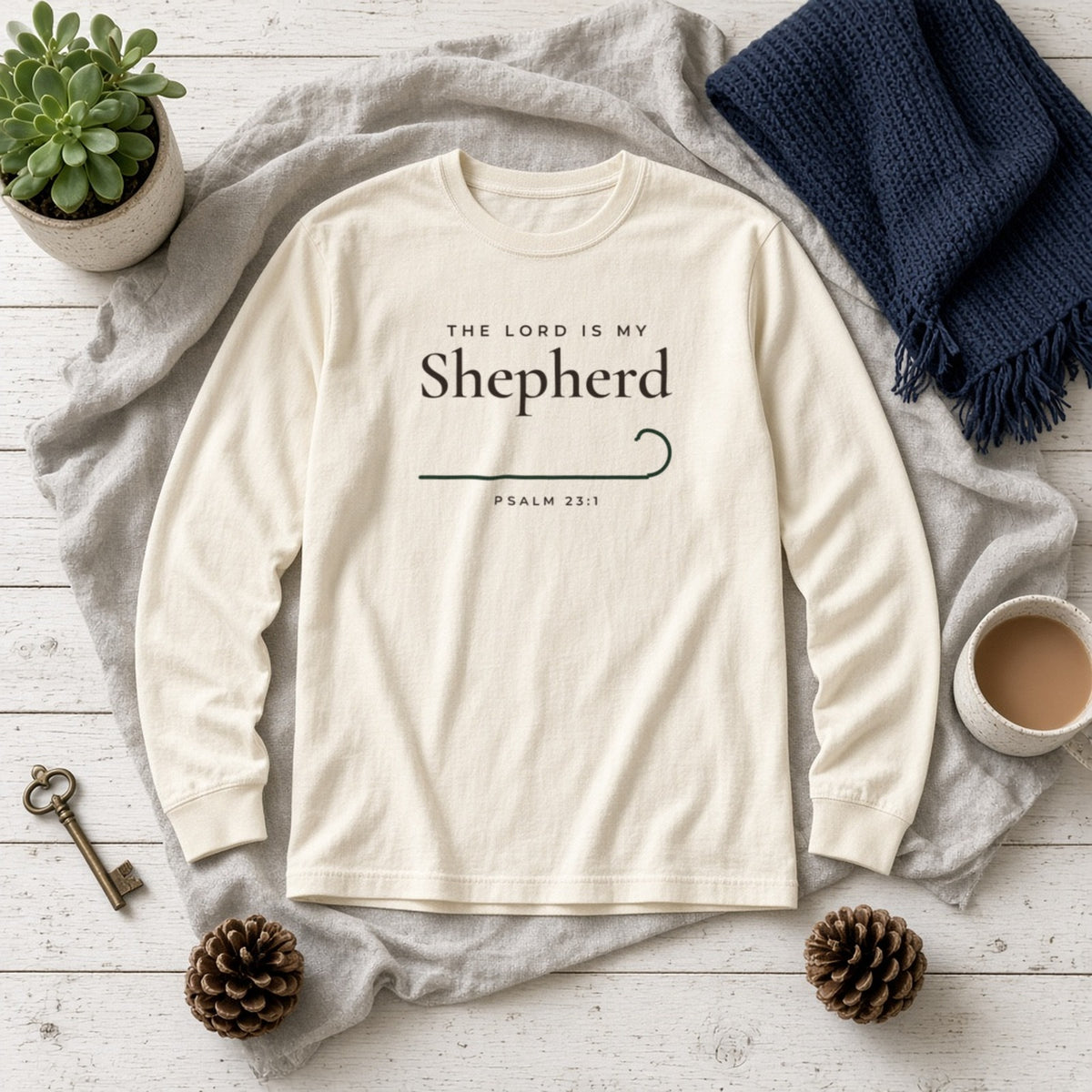 The Lord Is My Shepherd Psalm 23:1 Christian long sleeve tee in ivory, styled flat lay