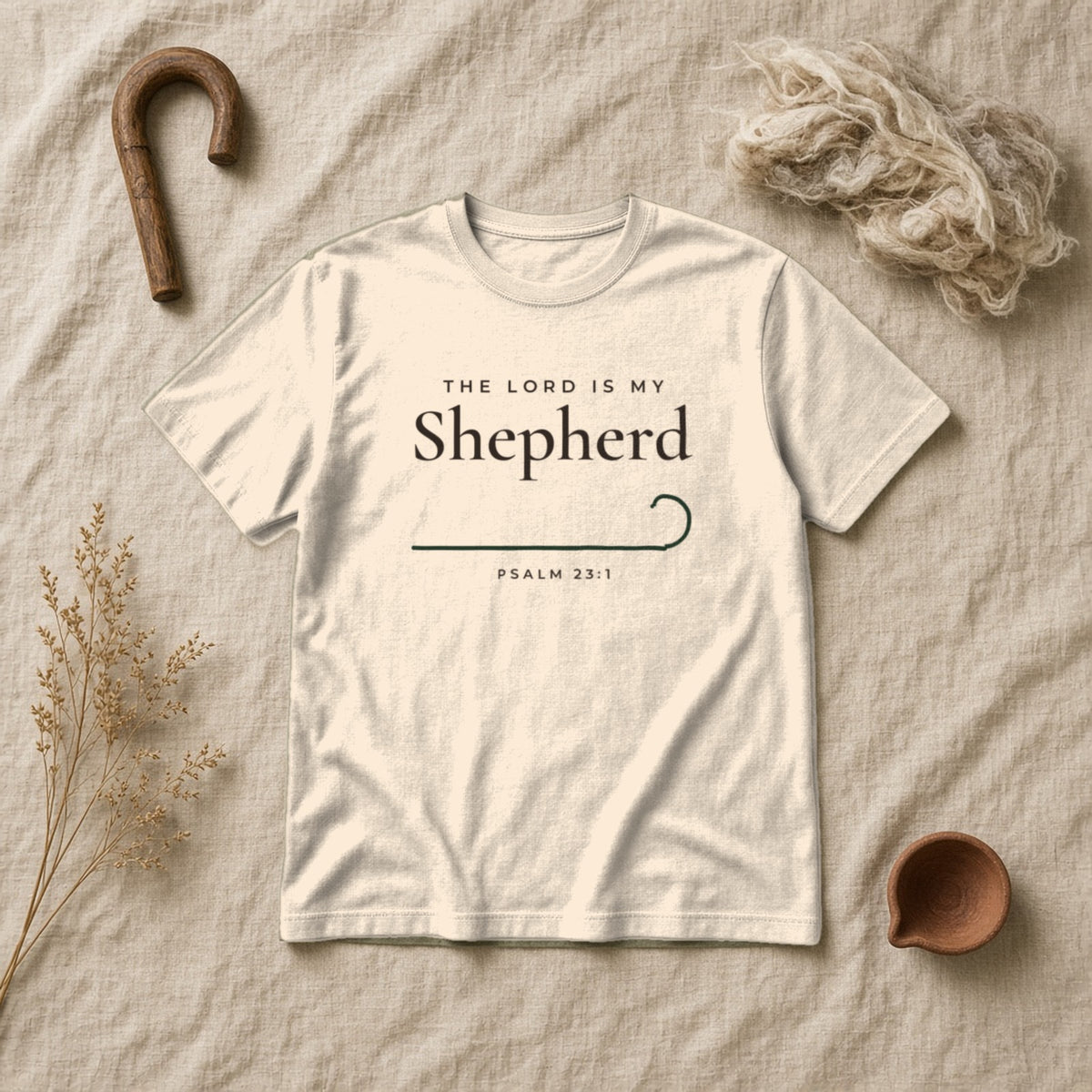 The Lord Is My Shepherd Psalm 23:1 Christian tee in ivory, styled flat lay