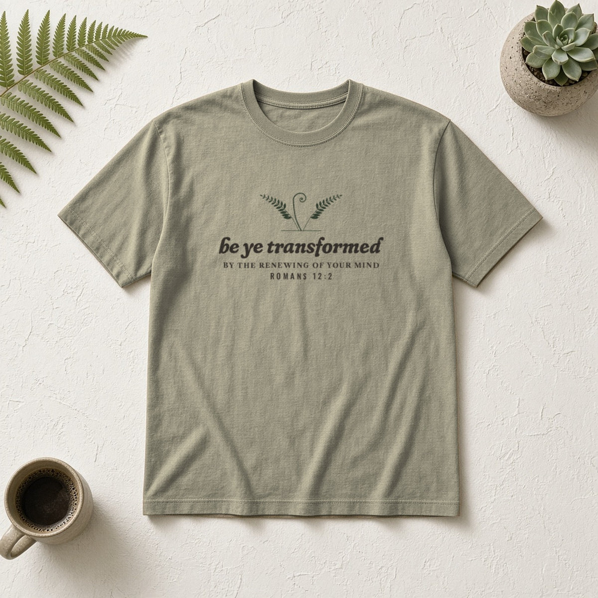 Be Transformed Romans 12:2 tee in Sandstone, flat lay