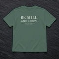 Be Still and Know Psalm 46:10 blue spruce tee, flat lay