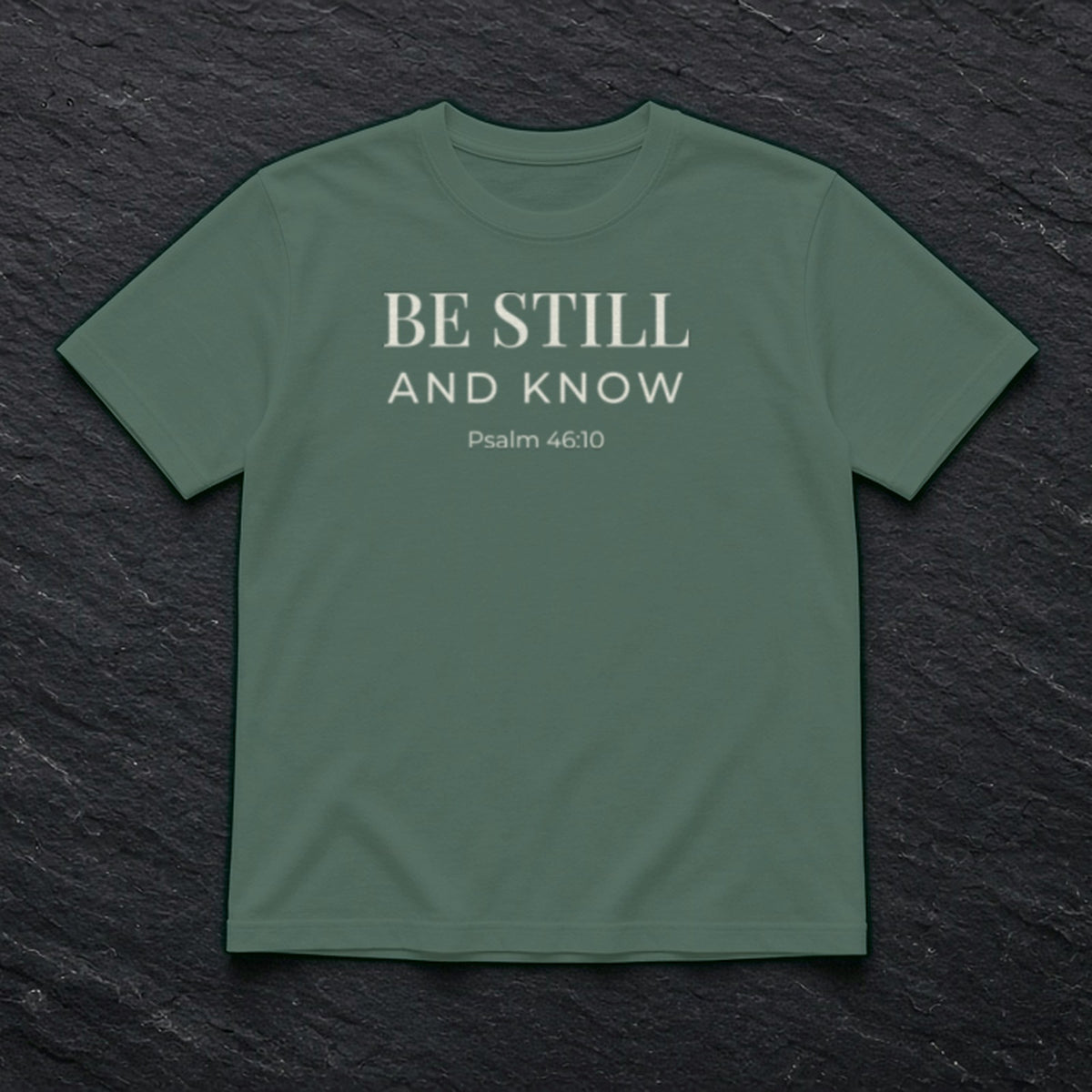 Be Still and Know Psalm 46:10 blue spruce tee, flat lay
